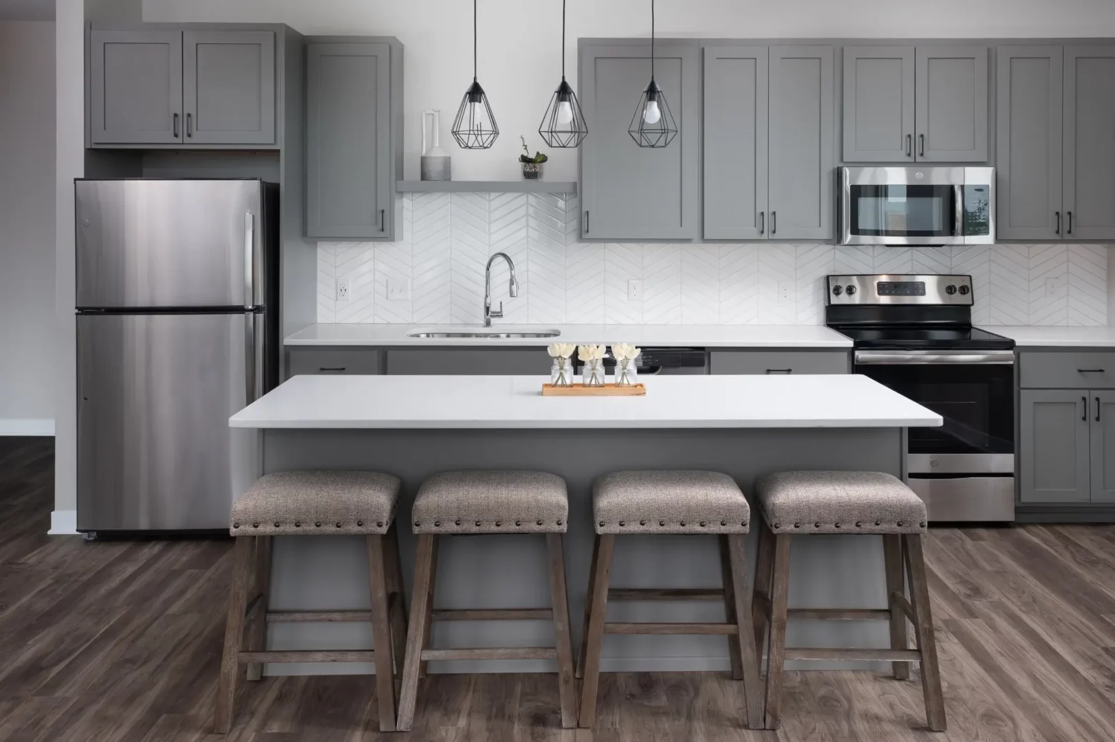 a kitchen with a bar and stools.
